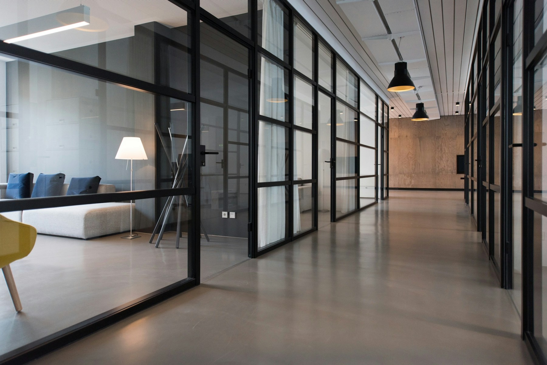 Sunlit modern office with clean floors, comfortable seating, and expansive windows
